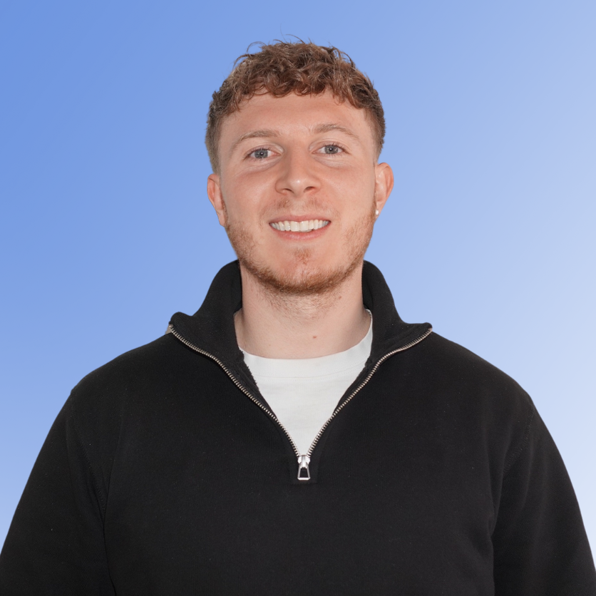 Max Von Niebel, Recruitment Consultant at ACE Partners, smiling in a black quarter-zip sweater against a light blue background.