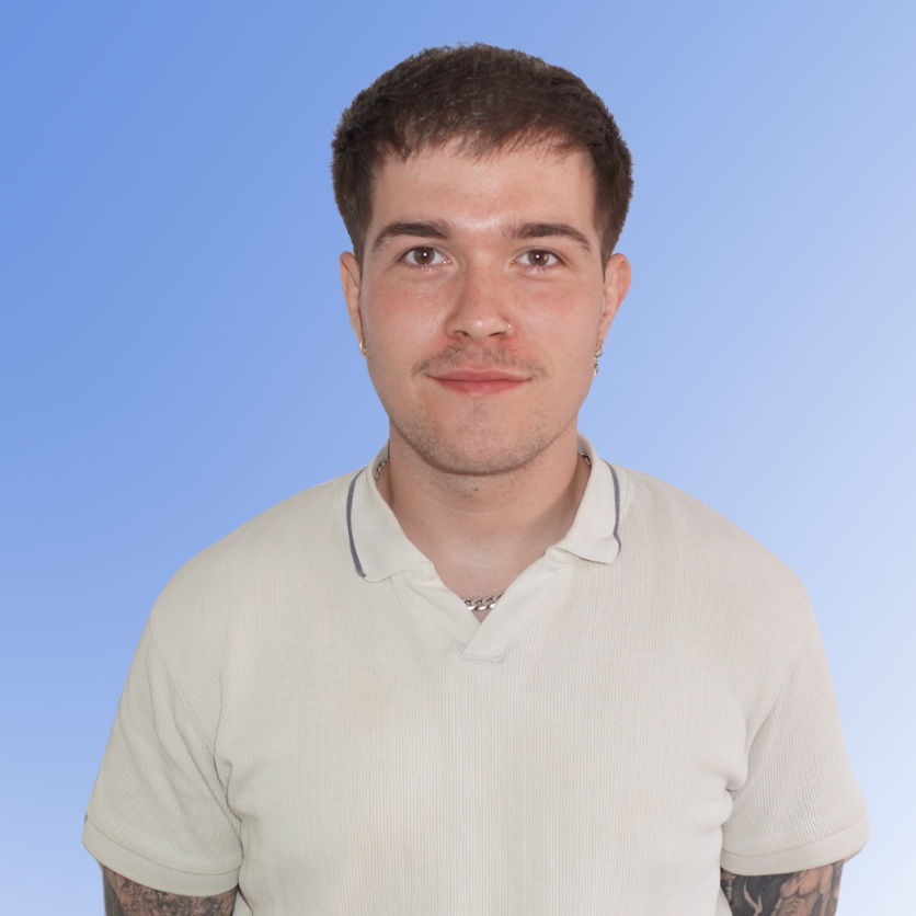 Oliver Adamson, Recruitment Consultant at ACE Partners, wearing a light polo shirt with tattoos visible, against a blue background.