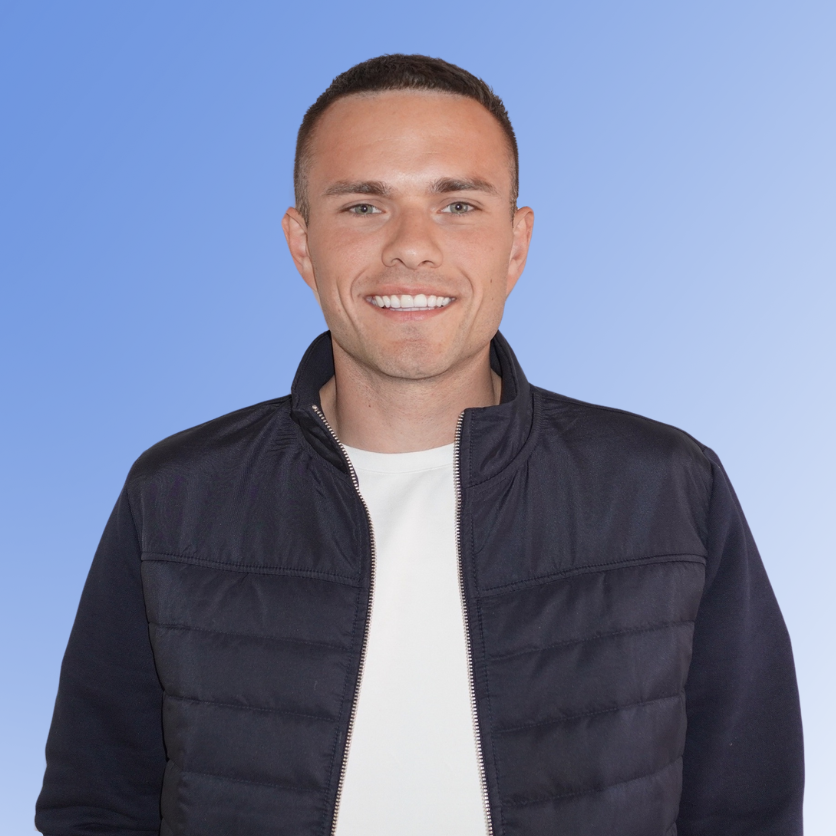 Thomas Hatfield, Head of Regulatory & Quality Assurance at ACE Partners, smiling in a dark jacket on a blue background.